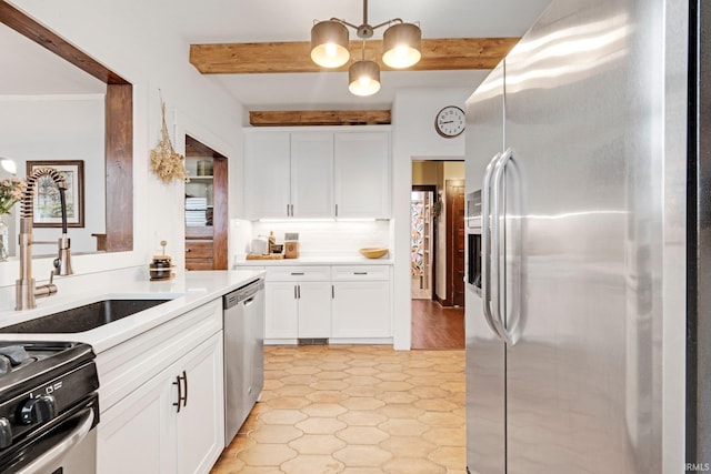 kitchen featuring white cabinets, a sink, appliances with stainless steel finishes, and beam ceiling