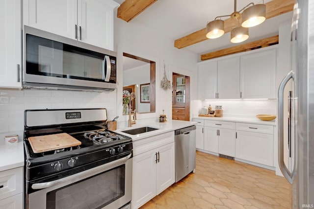 kitchen featuring appliances with stainless steel finishes, beam ceiling, a sink, light countertops, and decorative backsplash