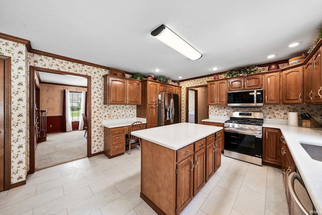 14157 Tenbury Dr, Granger, IN 46530 - kitchen with light countertops, a center island, appliances with stainless steel finishes, and wallpapered walls