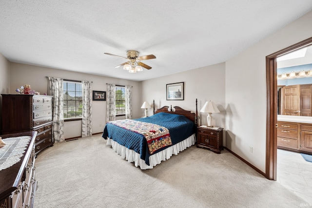 14157 Tenbury Dr, Granger, IN 46530 - bedroom featuring a textured ceiling, ensuite bath, ceiling fan, light carpet, and baseboards