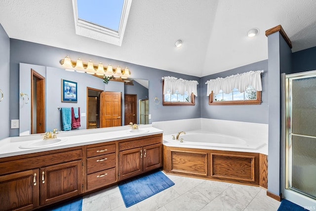 14157 Tenbury Dr, Granger, IN 46530 - full bathroom with a sink, a stall shower, a bath, and vaulted ceiling with skylight