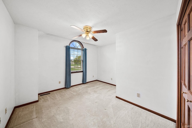 14157 Tenbury Dr, Granger, IN 46530 - spare room with a ceiling fan, a textured ceiling, baseboards, and light colored carpet