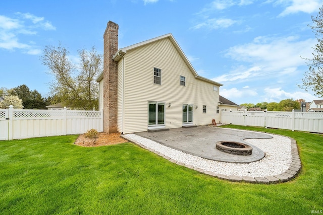 14157 Tenbury Dr, Granger, IN 46530 - back of property featuring a yard, an outdoor fire pit, a patio area, and a chimney