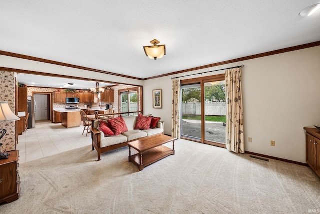 14157 Tenbury Dr, Granger, IN 46530 - living area with light colored carpet, crown molding, visible vents, and baseboards