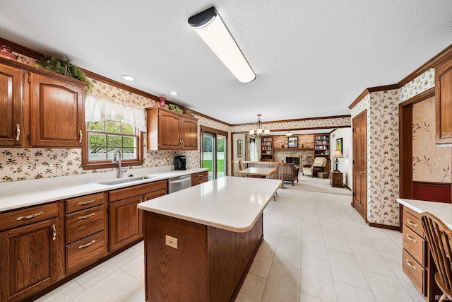 14157 Tenbury Dr, Granger, IN 46530 - kitchen featuring a center island, a sink, wallpapered walls, light countertops, and ornamental molding