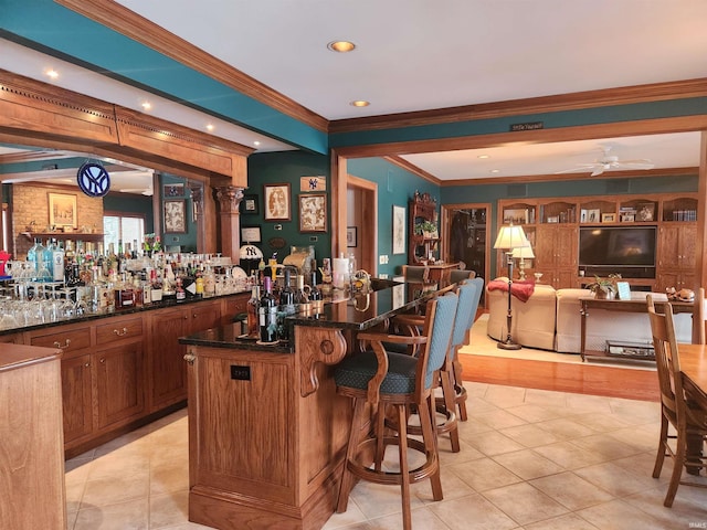 bar with a ceiling fan, light tile patterned floors, indoor wet bar, ornamental molding, and recessed lighting
