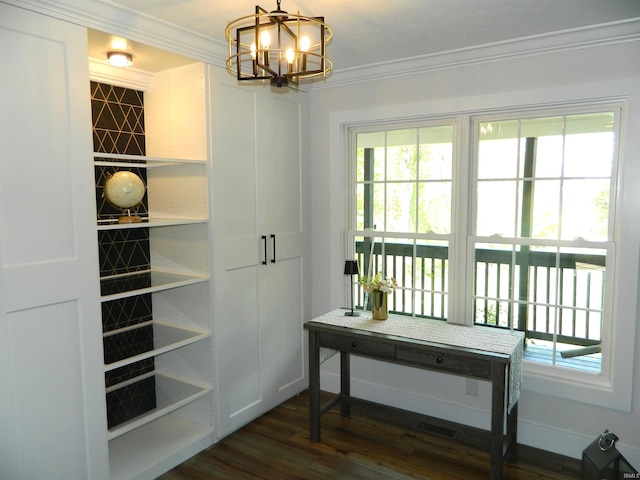 doorway to outside with ornamental molding, dark wood-type flooring, and a chandelier