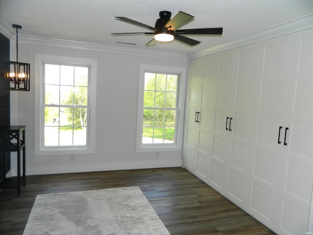 unfurnished bedroom with crown molding, baseboards, dark wood finished floors, and a closet