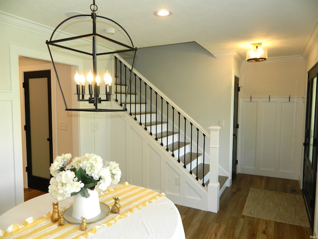 interior space featuring crown molding, recessed lighting, wood finished floors, and a notable chandelier