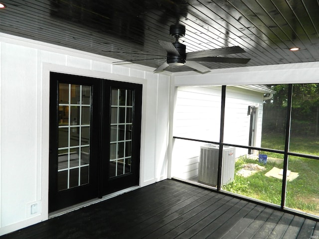unfurnished sunroom featuring a ceiling fan and french doors