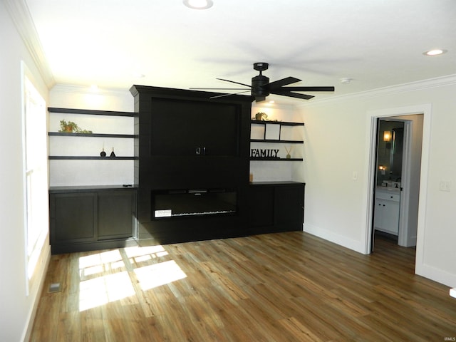 unfurnished living room featuring crown molding, ceiling fan, baseboards, and wood finished floors