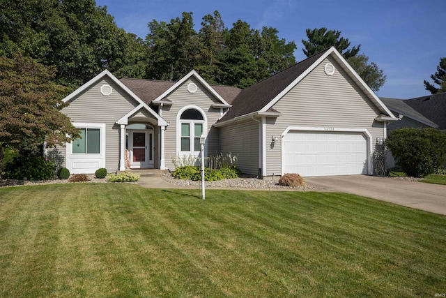 view of front facade featuring a garage, a front yard, and concrete driveway