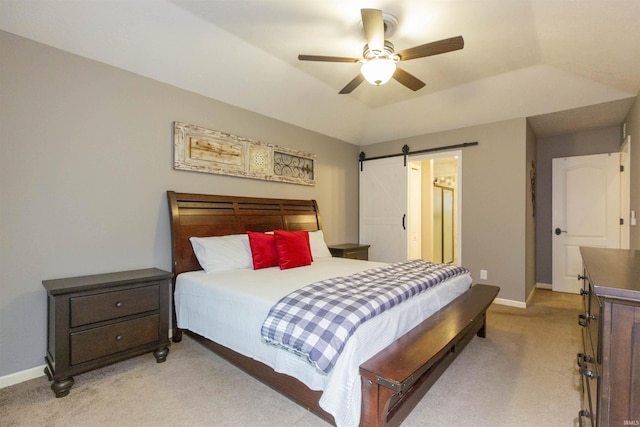 bedroom featuring baseboards, light carpet, a ceiling fan, and a barn door