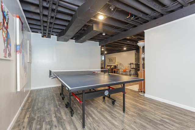 rec room with baseboards and wood finished floors
