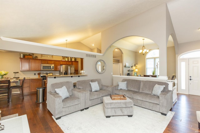 living room with an inviting chandelier, arched walkways, lofted ceiling, visible vents, and dark wood-style floors