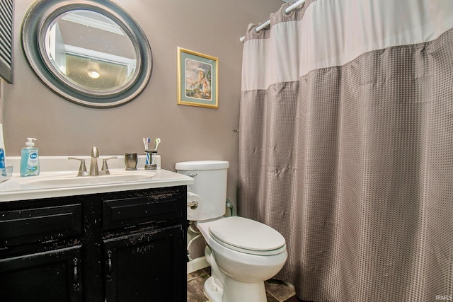 full bath with tile patterned floors, vanity, and toilet