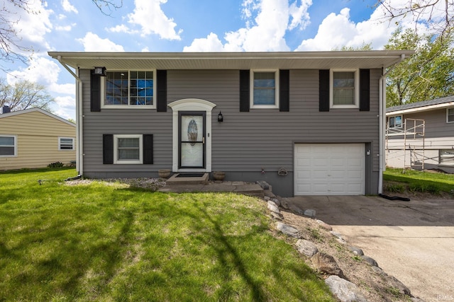 split foyer home with a garage, concrete driveway, and a front yard