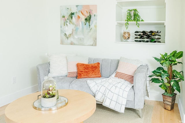 sitting room with baseboards and wood finished floors