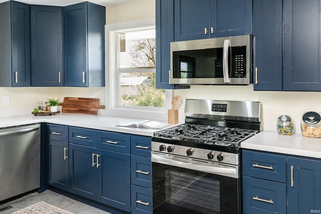 kitchen with light countertops, stainless steel appliances, and blue cabinetry