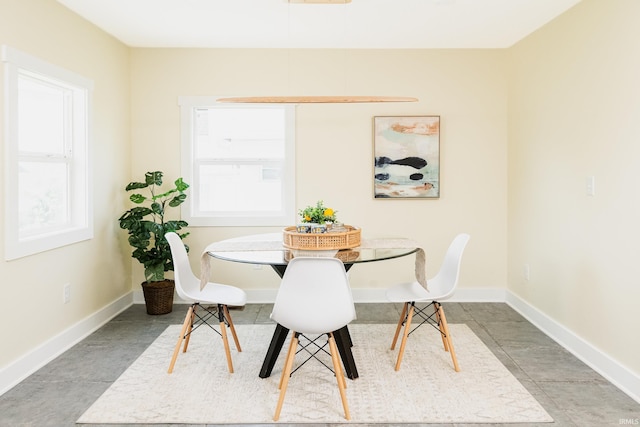 dining area featuring baseboards