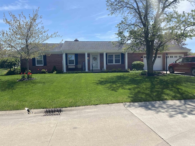 ranch-style house with brick siding, a garage, and a front lawn