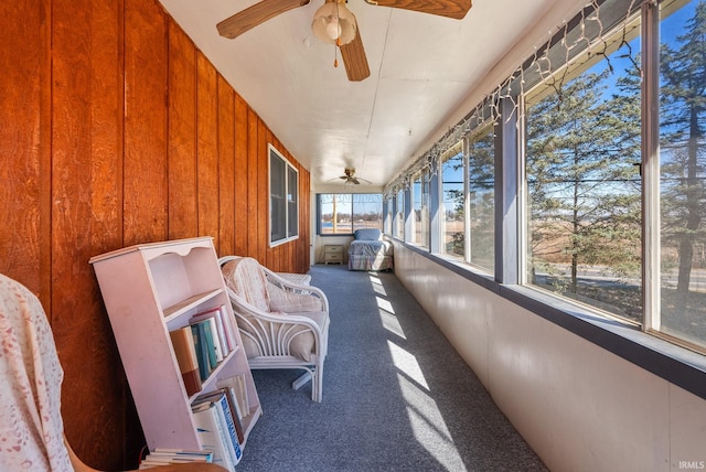 sunroom / solarium featuring a ceiling fan