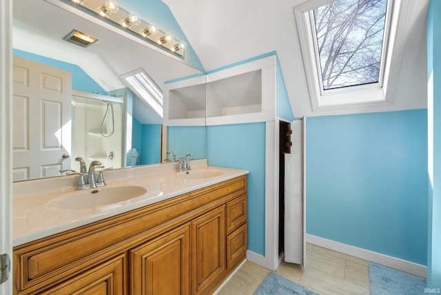 full bath with a sink, a shower stall, lofted ceiling with skylight, and double vanity
