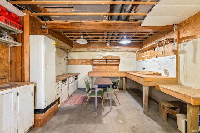 unfinished basement with a workshop area
