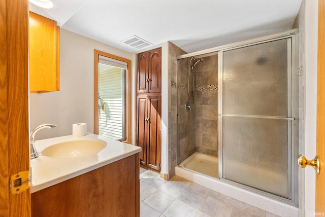 full bath with vanity, visible vents, tile patterned flooring, and a stall shower