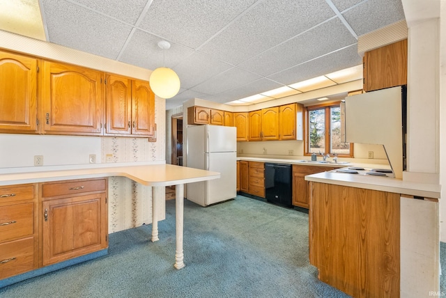 kitchen featuring freestanding refrigerator, a peninsula, a drop ceiling, black dishwasher, and light colored carpet