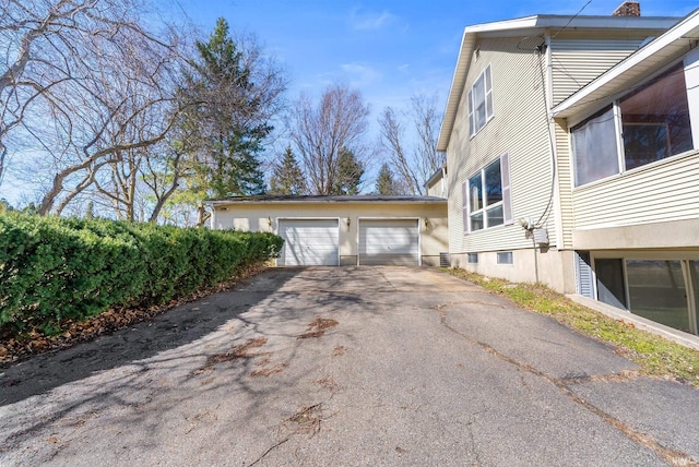 view of side of property featuring aphalt driveway
