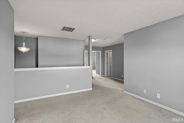 unfurnished room featuring baseboards, carpet flooring, and visible vents