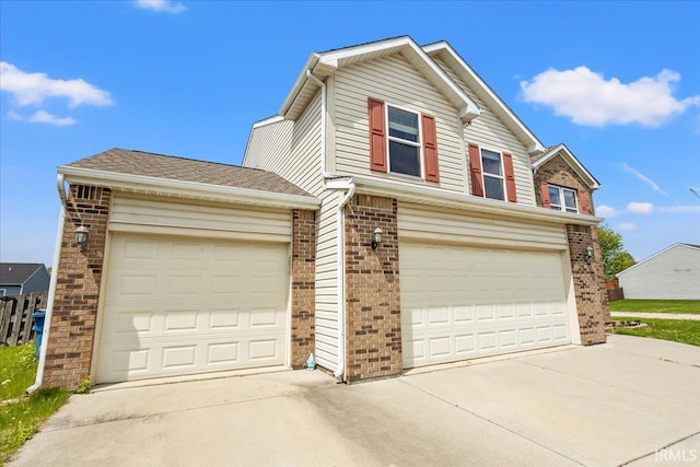 view of front of house with brick siding, an attached garage, and concrete driveway