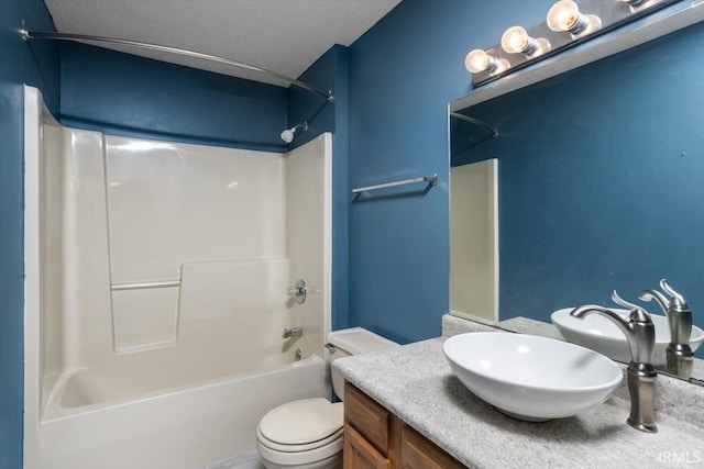 full bathroom featuring vanity, shower / bathing tub combination, toilet, and a textured ceiling
