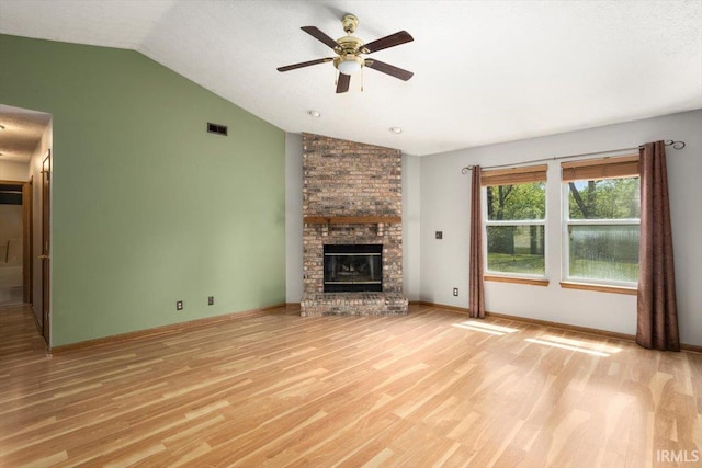 unfurnished living room with visible vents, a ceiling fan, light wood-style flooring, and lofted ceiling