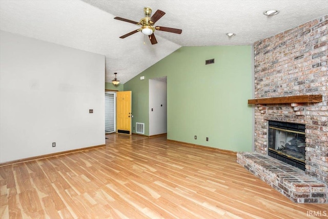 unfurnished living room with visible vents, ceiling fan, wood finished floors, and vaulted ceiling