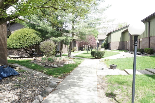 view of home's community featuring fence and a yard