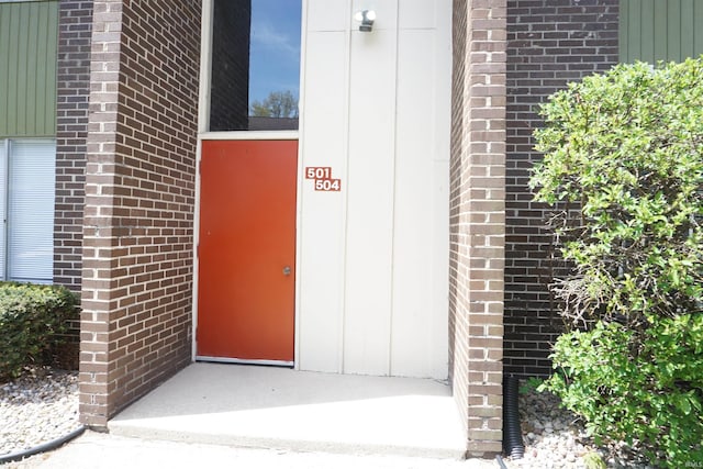 property entrance with brick siding
