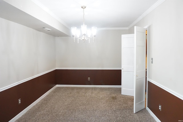 carpeted empty room featuring crown molding, baseboards, and a chandelier