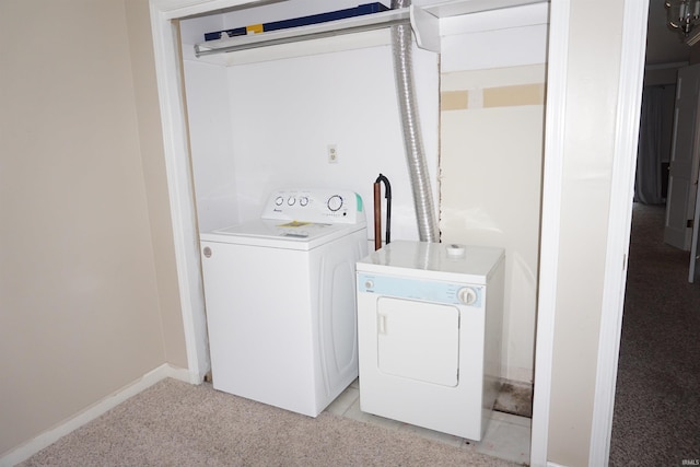 laundry room with separate washer and dryer and light carpet