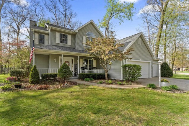 53225 Sugar Maple Ct, Bristol, IN 46507 - traditional-style house featuring covered porch, driveway, a chimney, a front yard, and a garage