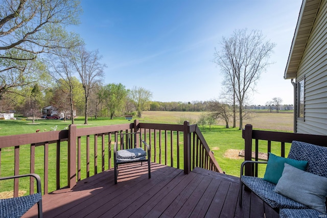 deck with a yard and a rural view