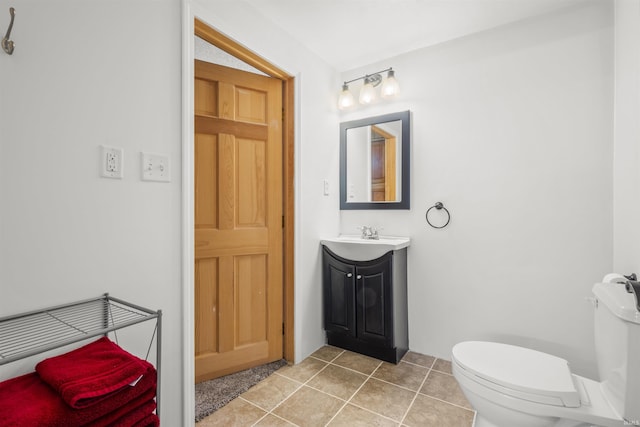 half bath with vanity, tile patterned flooring, and toilet