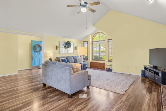 living area with vaulted ceiling, baseboards, a ceiling fan, and wood finished floors