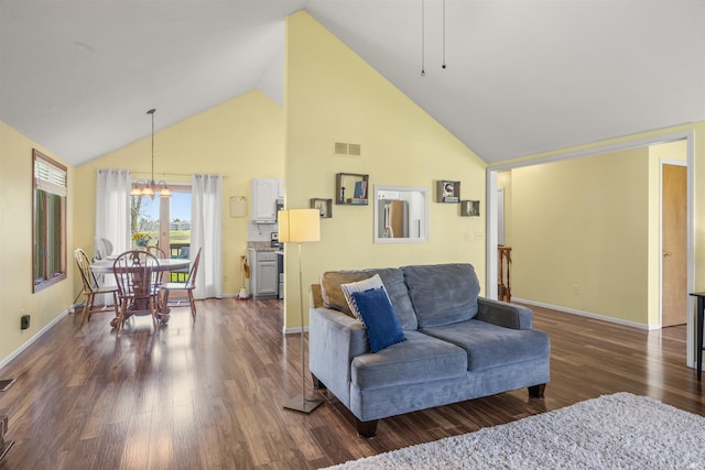 living area featuring visible vents, baseboards, dark wood-style floors, high vaulted ceiling, and a chandelier