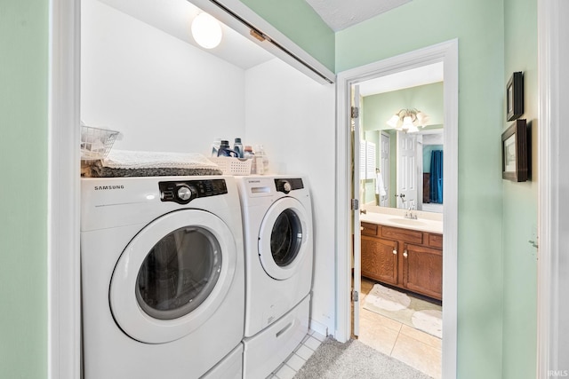 laundry room with separate washer and dryer, laundry area, light tile patterned flooring, and a sink