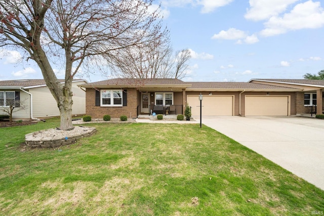 single story home featuring brick siding, a garage, a front yard, concrete driveway, and covered porch