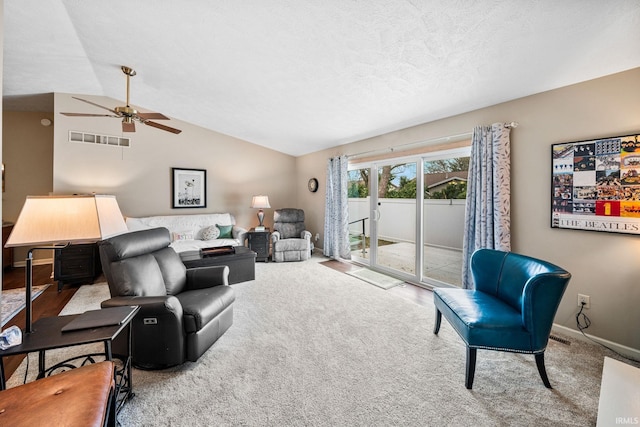 living area with a textured ceiling, carpet, a ceiling fan, lofted ceiling, and visible vents