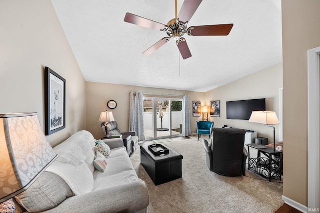 living area featuring ceiling fan, carpet flooring, and lofted ceiling