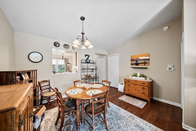 dining space with baseboards, a chandelier, wood finished floors, and lofted ceiling